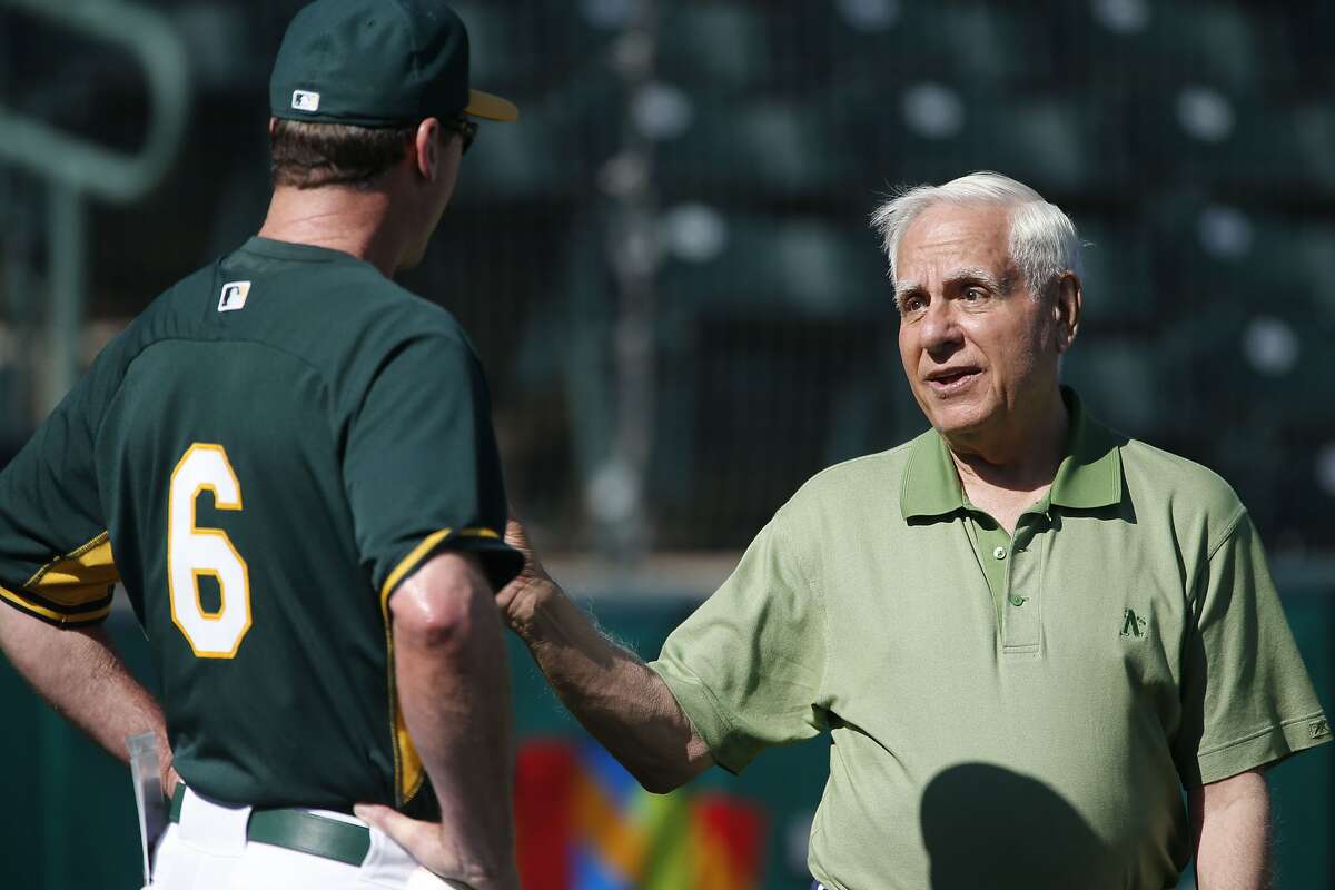 A's owner Lew Wolff talks with A's manager Bob Melvin as he makes a visit to morning workouts while the Oakland Athletics prepare to take on the Milwaukee Brewers in spring training game action at Phoenix Stadium, in Phoenix, Arizona on Thursday Feb. 27, 2014.
