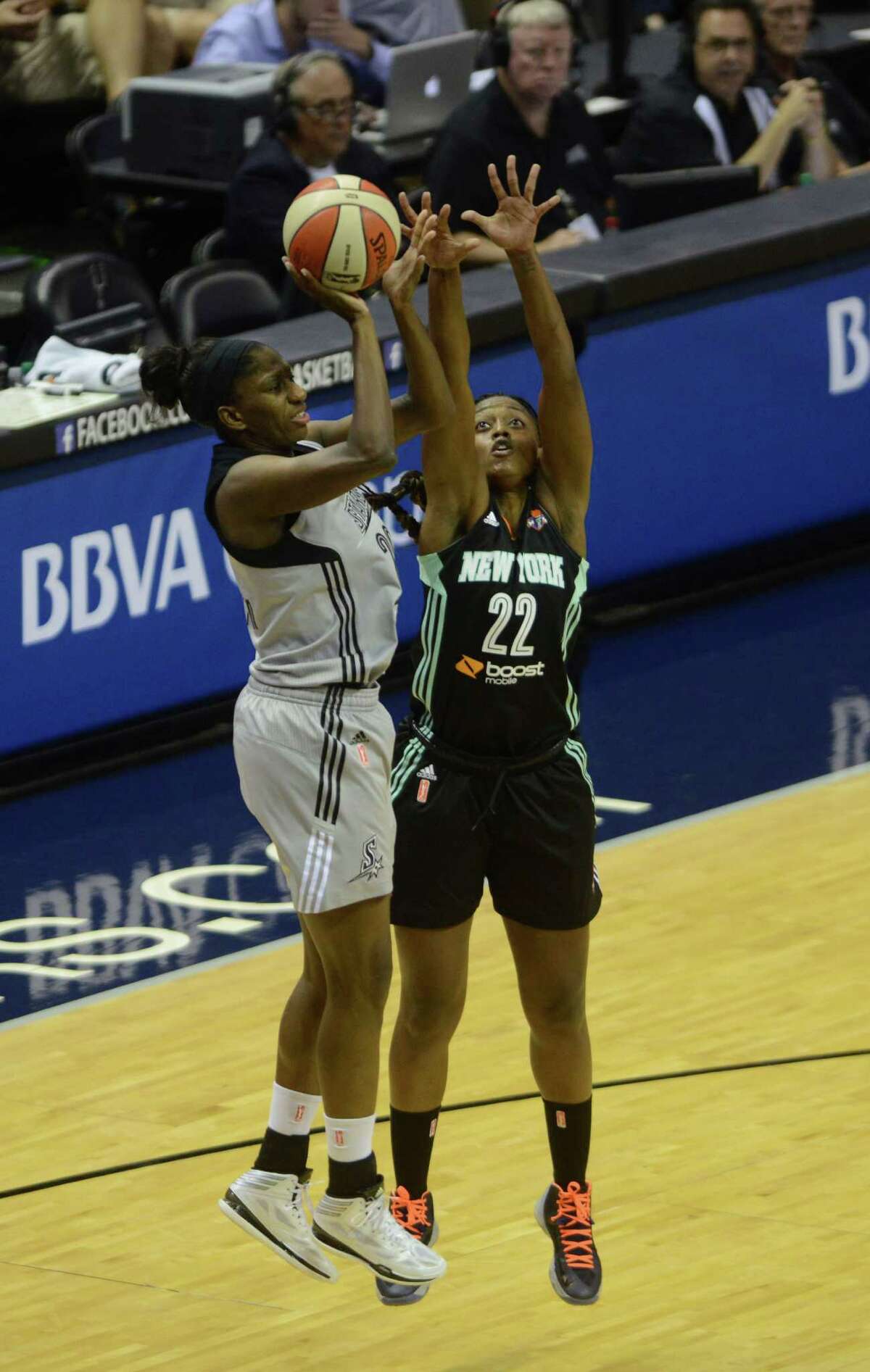Shameka Christon of the San Antonio Stars, left, shoots as Charde Houston of the New York Liberty defends during WNBA action in the AT&T Center on Wednesday, July 9, 2014.