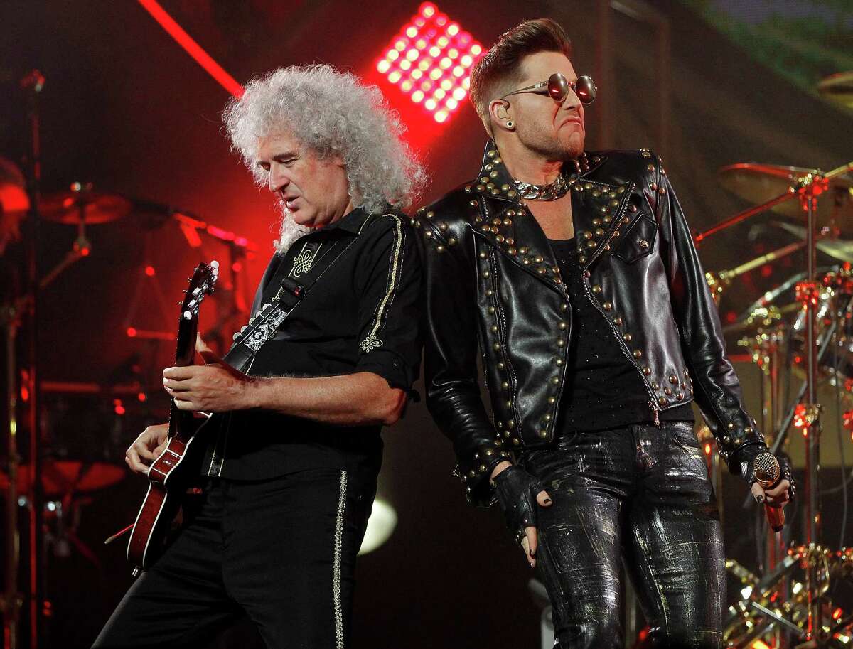 Guitarist Brian May stands next to Adam Lambert as Queen performs at the Toyota Center, Wednesday, July 9, 2014, in Houston.
