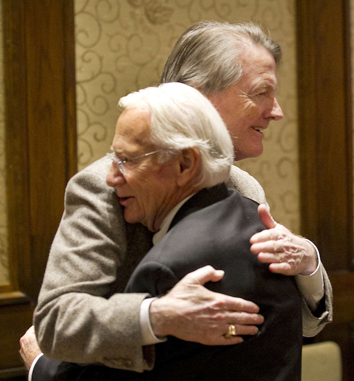 University of Texas at Austin President Bill Powers, right, hugs Regent Robert L. Stillwell as he attends the UT System Board of Regents meeting Thursday morning December 12, 2013. Powers was to discuss a specific agenda item but after the morning business the regents recessed to move into Executive Session. A possible decision on whether Powers will remain as President could be discussed in that session. RALPH BARRERA / AMERICAN-STATESMAN