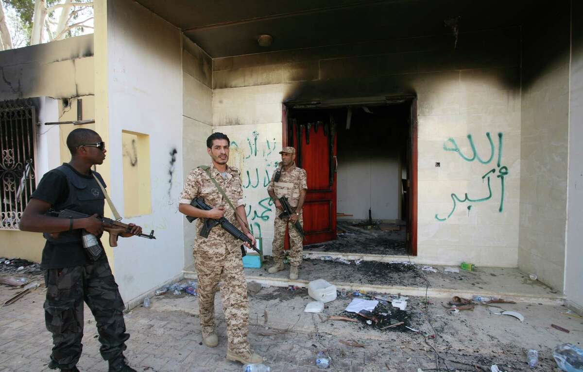 FILE - This Sept. 14, 2012, file photo shows Libyan military guards as they check one of the U.S. Consulate's burnt out buildings after a deadly attack on Tuesday, September 11, 2012, in Benghazi. The testimony of nine military officers severely undermines claims by Republican lawmakers that a âstand-down orderâ held back military assets who could have saved the U.S. ambassador and three other Americans killed at a diplomatic outpost and CIA annex in Benghazi, Libya. (AP Photo/Mohammad Hannon, File)