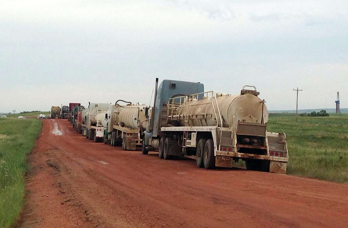 Trucks wait to help clean up the site of a saltwater spill near Mandaree, N.D. It could take weeks to clean up after a pipeline leaked 1 million gallons of saltwater in the heart of North Dakota's booming oil patch.