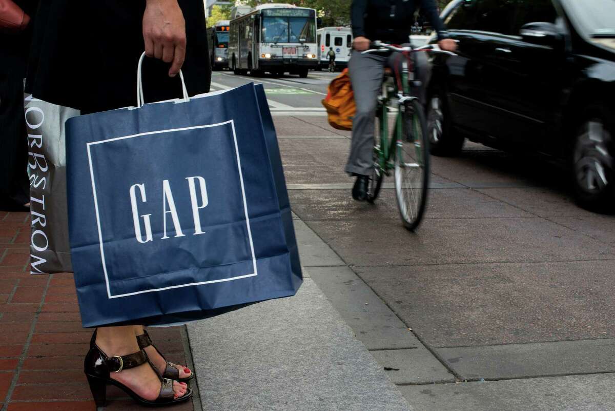 A shopper waits to cross Market Street in San Francisco, the home city of Gap.