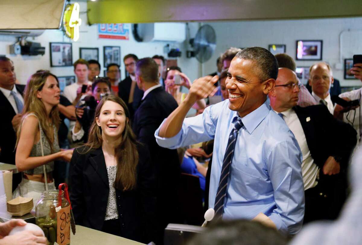 President Barack Obama visits Franklin Barbecue in Austin with Kinsey Button, left, a UT student from Houston who wrote the president about her family's job struggles.