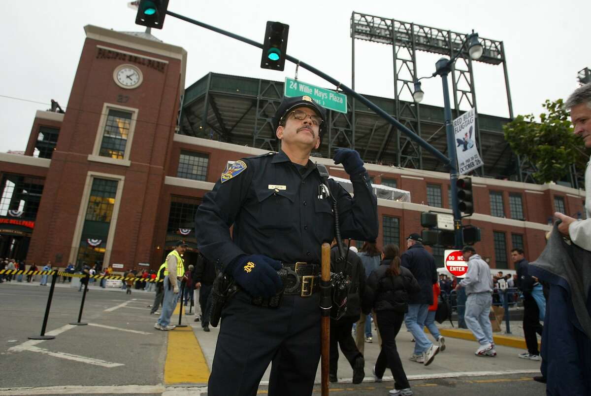 In this file photo, San Francisco police patrolman Kevin Martin works Second and King streets. A group of fans got into an argument at Second and King streets after the A's beat the Giants in the last game of the four-game Bay Bridge Series.