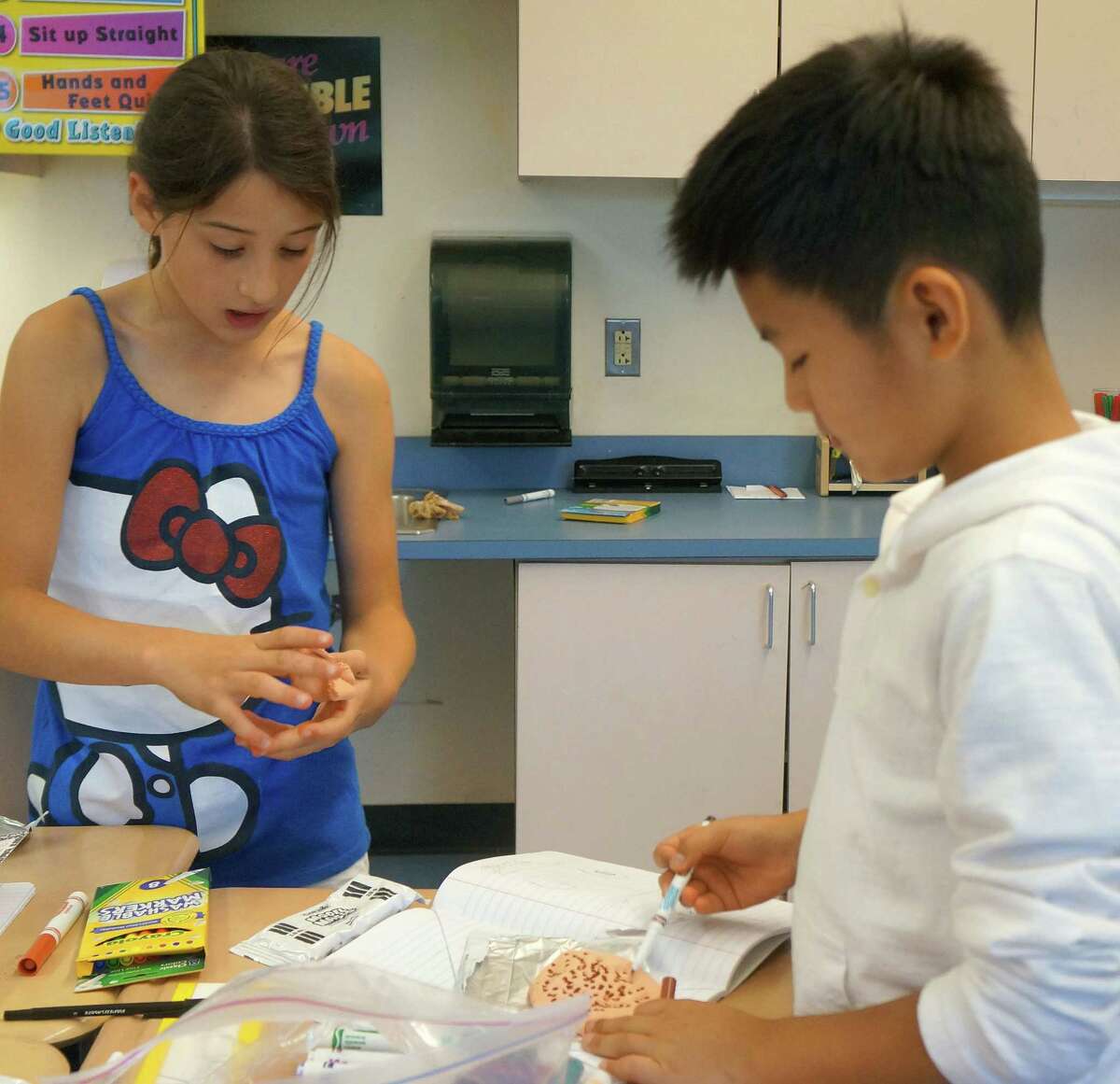 Sofia Ruiz and Jay Kim, rising fifth-graders at Julian Curtiss School, make sculptures during an art class on Friday, July 11, at Cos Cob School.