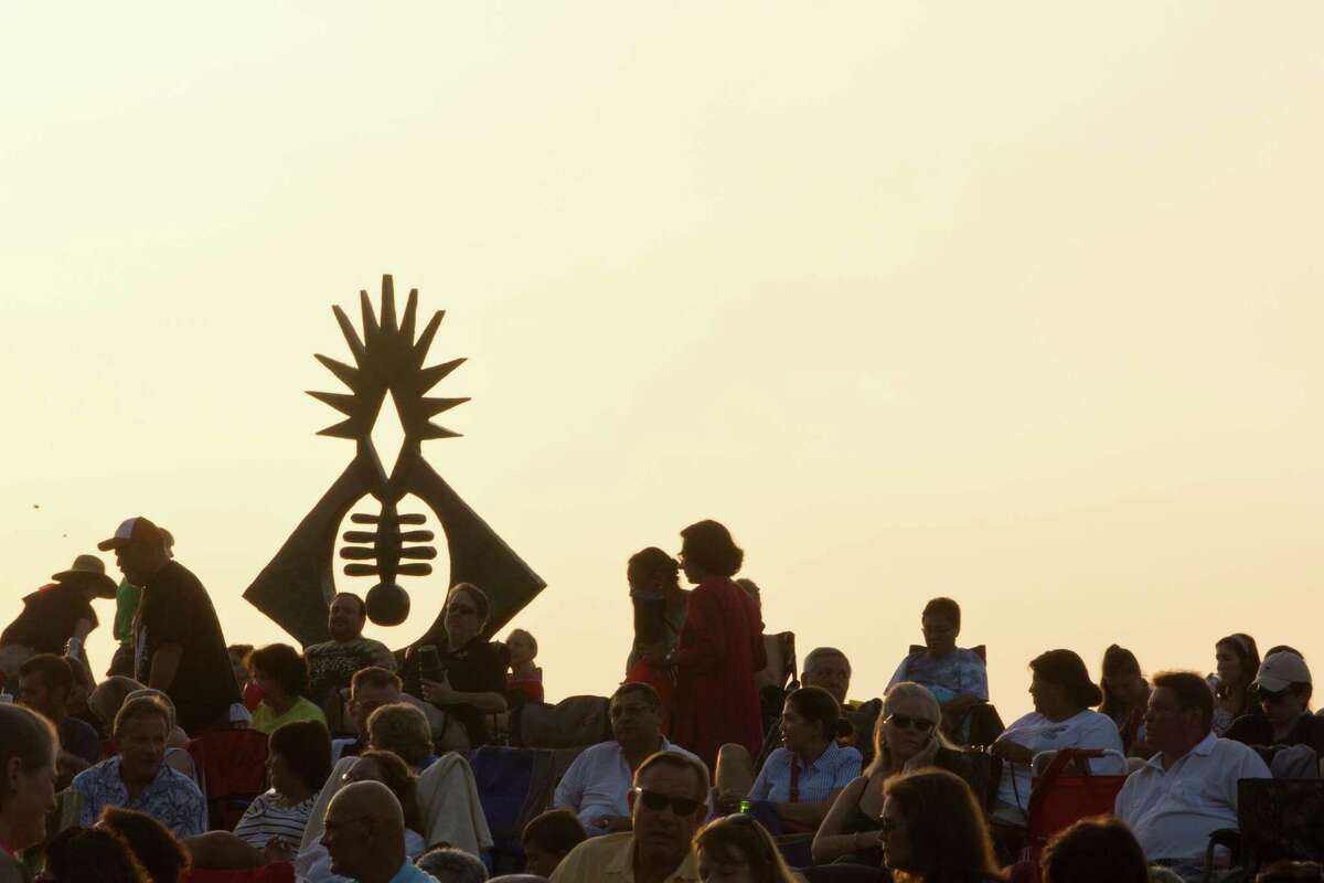The Atropos Key sculpture is silhouetted by the afternoon light and surrounded by Miller Outdoor Theatre audience at the Hill. The Atropos Key was made out of bronze and concrete, and created in 1972 by Hannah Holliday Stewart. Wednesday, July 2, 2014, in Houston. ( Marie D. De Jesus / Houston Chronicle )