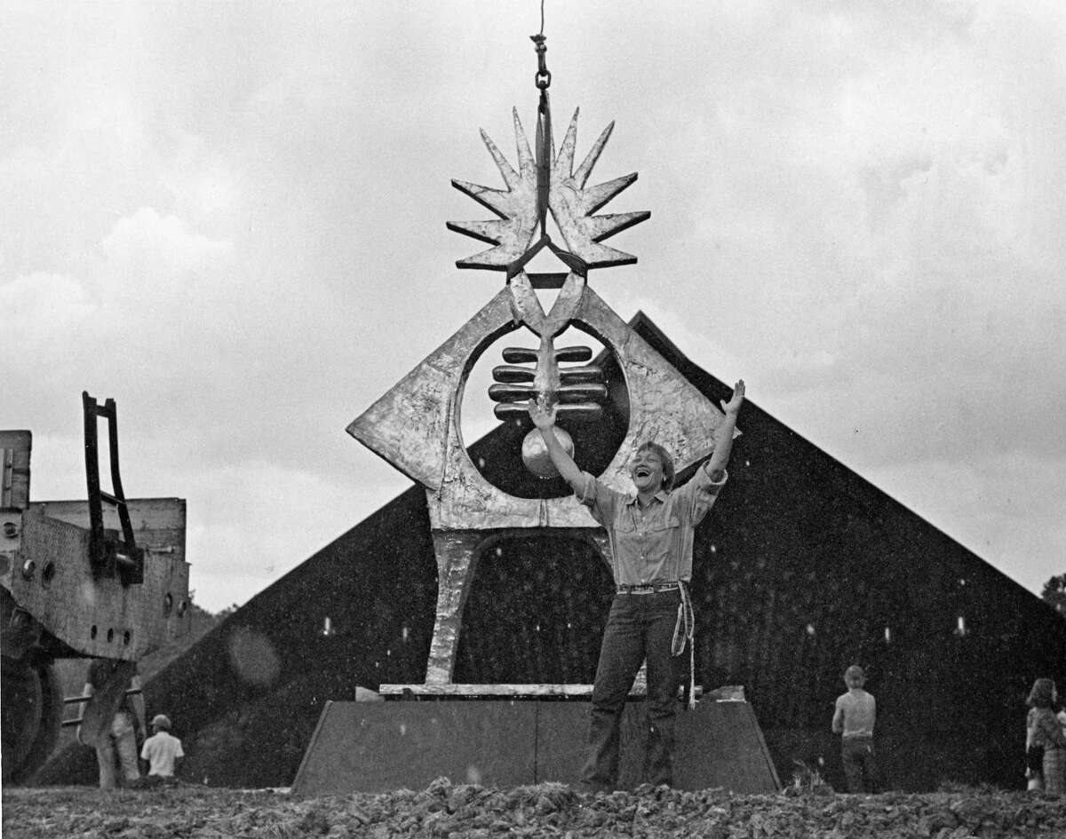 Sculptor Hannah Holiday Stewart reacts joyfully as her monumental bronze "Atropos Key" is installed on the hill at Miller Outdoor Theater in Hermann Park in 1972.