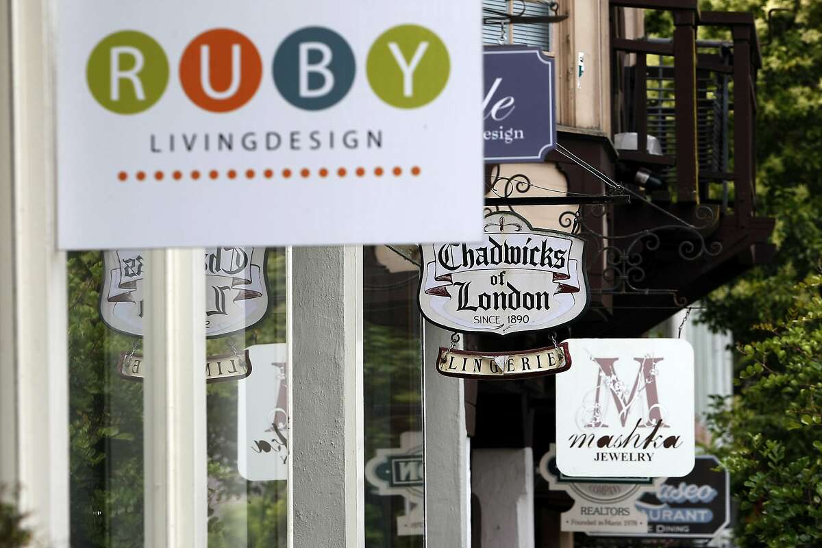 Signs for luxury shops are seen in Mill Valley, CA, Friday, July 11, 2014.