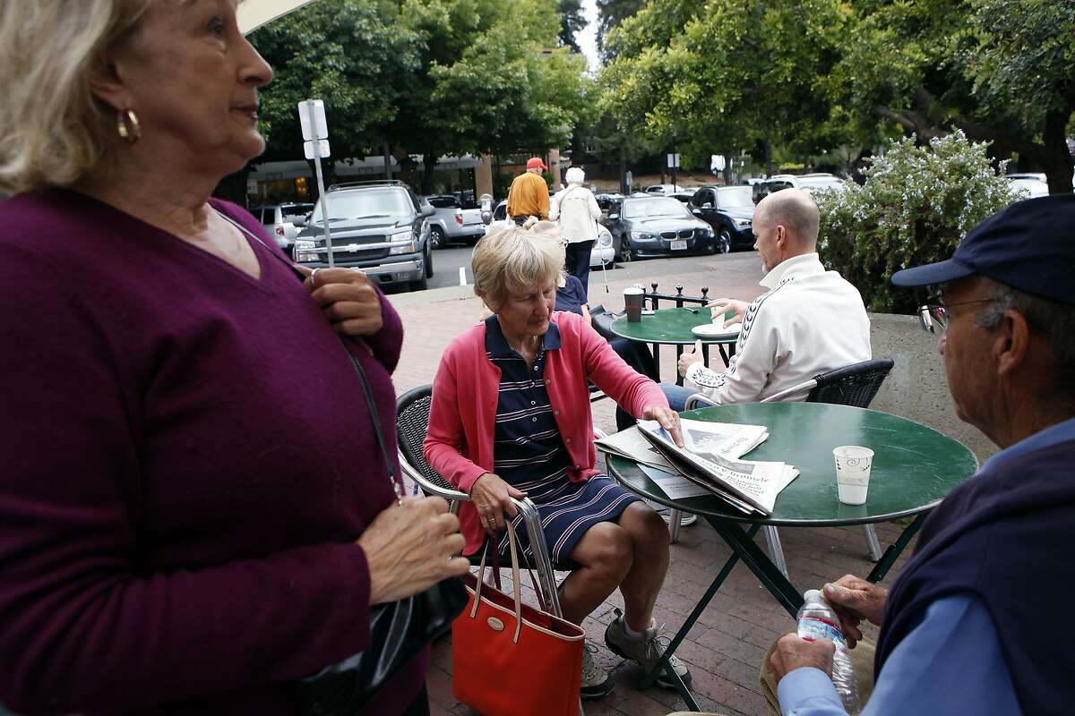 Elaine Gentile, left, talks with Susie and Britt Stitt of inverness at the Depot coffee shop and bookstore in Mill Valley, CA, Friday, July 11, 2014.