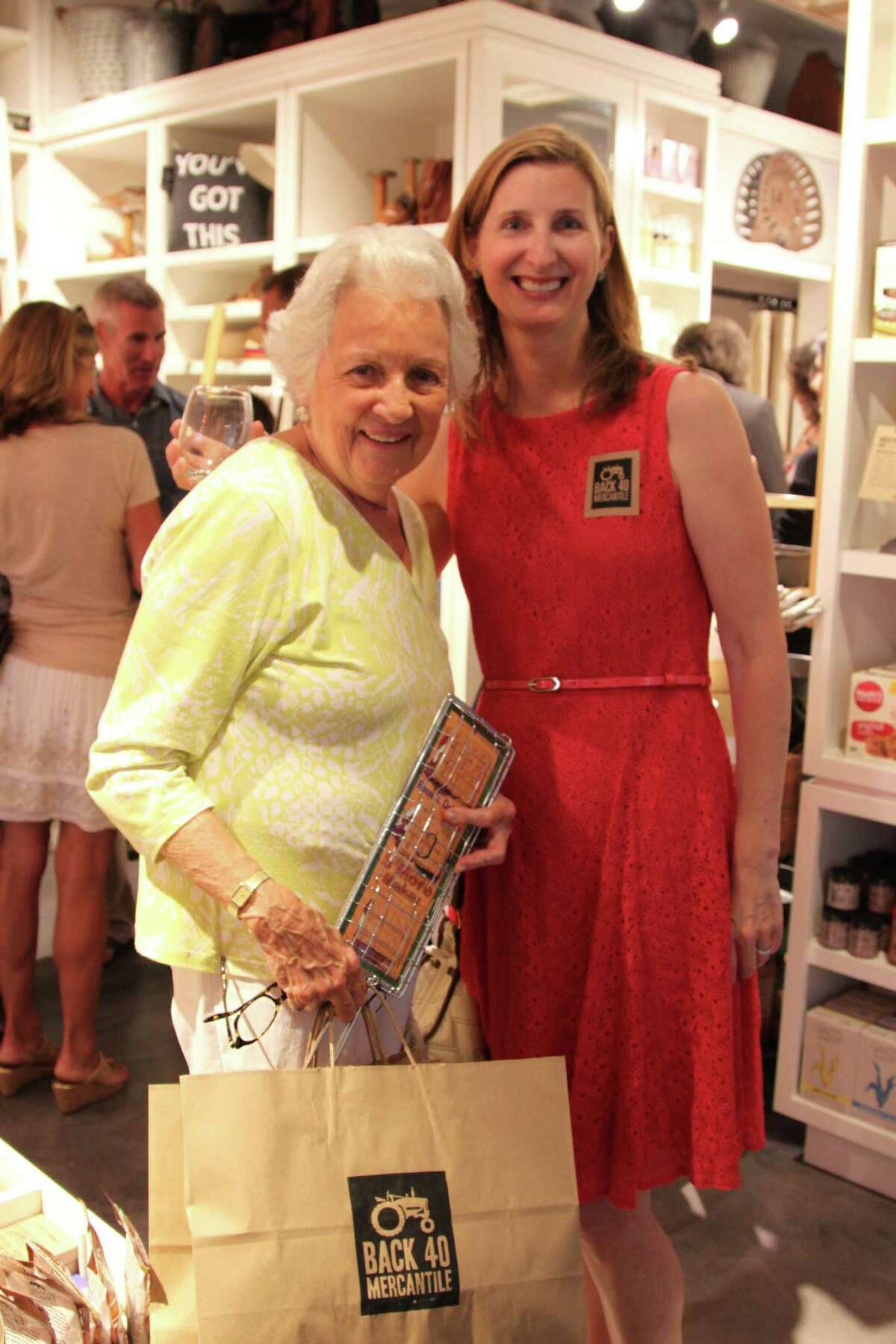 Lesley King, right, co-owner of Back 40 Mercantile, welcomes her neighbor, Old Greenwich native Sue Millard to Back 40's opening party in Old Greenwich on Wednesday evening.