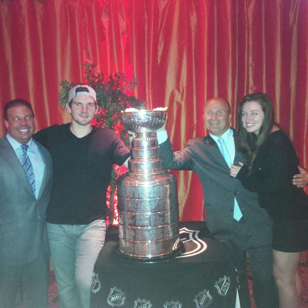 Goalie Jonathan Quick shares the Stanley Cup trophy with, from left, Gabriele's owner Danny Gabriele,Tony Capasso and wife Jaclyn Quick at Gabriele's Italian Steakhouse on Monday night.