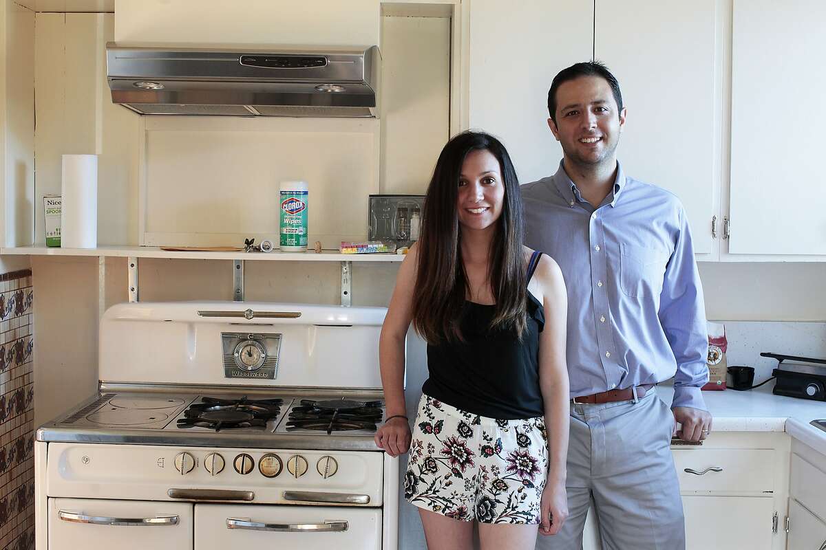 Arin, left, and Merve Keskin pose in their new home that they've lived in for a little over a month South San Francisco, Calif. on Thursday, July 10, 2014. The Keskins had help from Arin's mother who put a 36% downpayment on the home.