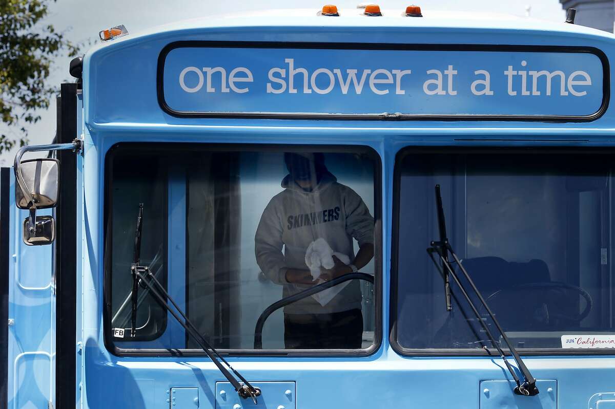 A homeless person emerged from his shower on the Lava Mae bus Tuesday June 24, 2014 in San Francisco, Calif. Lava Mae, the program that is turning old MUNI buses into showers for homeless people. began their test run in front of the Mission Neighborhood Resource Center.