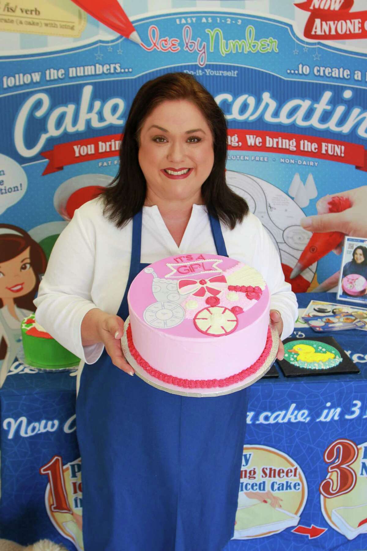 Pastry chef April Didrikson, holding partially decorated pattern It's A Girl, at the trade show display for her new product, Ice by Number, which anyone can use to decorate a cake. Ice by Number is the world's first edible pattern for decorating baked goods with icing. Ice by Number has a variety of patterns, including all occasional, seasonal and holiday designs. A national retailer will debut the Ice by Number product in their top 500 stores by this Christmas holiday season. Pastry chef April Didrikson, holding partially decorated pattern It's A Girl, at the trade show display for her new product, Ice by Number, which anyone can use to decorate a cake. Ice by Number is the world's first edible pattern for decorating baked goods with icing. Ice by Number has a variety of patterns, including all occasional, seasonal and holiday designs. A national retailer will debut the Ice by Number product in their top 500 stores by this Christmas holiday season.