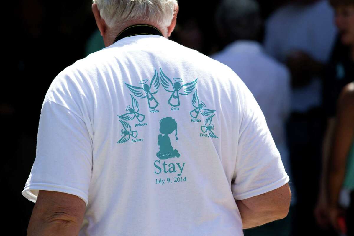 A shirt memorializing the Stay family is worn during a community memorial celebrating the lives of the family at Lemm Elementary School Saturday, July 12, 2014, in Spring.