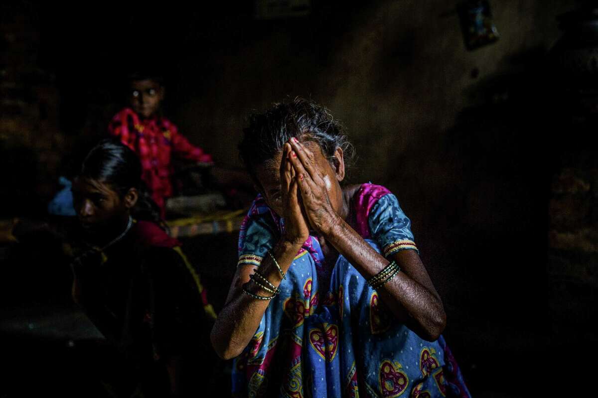 The mother of a 13-year-old girl who was raped as punishment for her brother's alleged assault weeps during an interview in Swang Gulgulia Dhoura, India, on Saturday. The authorities have arrested Ghosal Pasi, the village headman, on suspicion of ordering the rape, and his son-in-law on suspicion of rape.