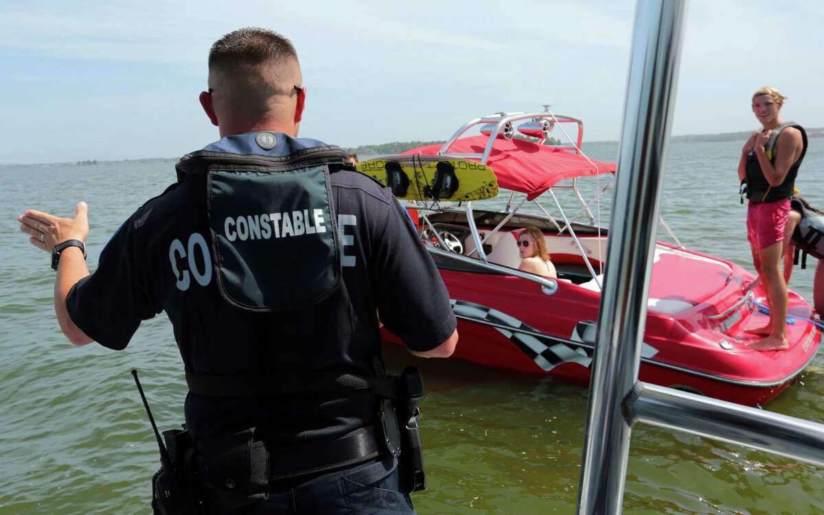 Lt. Tim Cade stops a boater on Lake Conroe for a safety check on Wednesday. All boaters are required to have life vests for each passenger onboard.