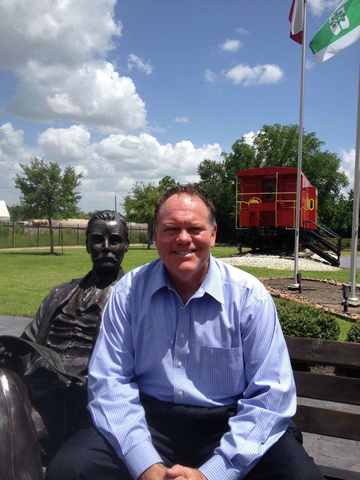 Tom Ball, here with Chamber President Bruce Hille­geist, may never have lived in his namesake town, but he has a permanent seat of honor on its village green.