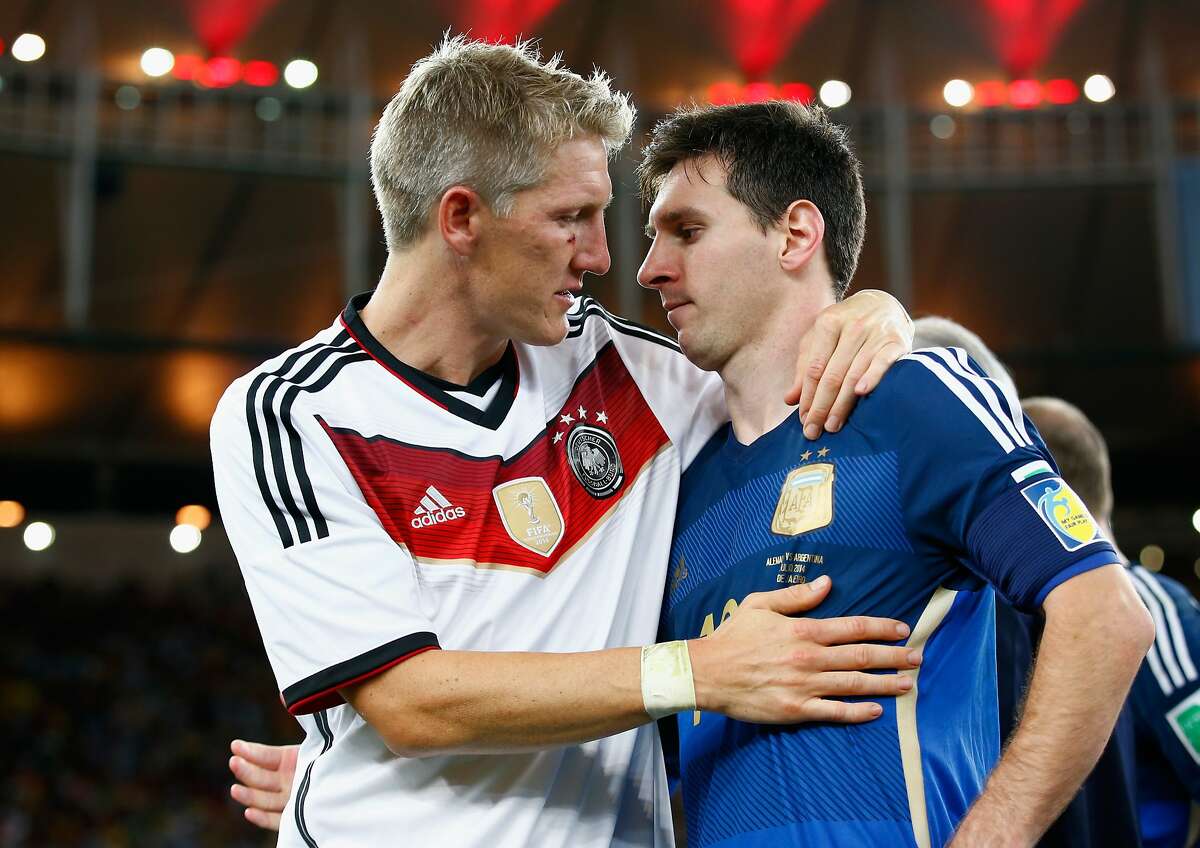 RIO DE JANEIRO, BRAZIL - JULY 13: Bastian Schweinsteiger of Germany hugs Lionel Messi of Argentina after Germany's 1-0 victory in extra time during the 2014 FIFA World Cup Brazil Final match between Germany and Argentina at Maracana on July 13, 2014 in Rio de Janeiro, Brazil. (Photo by Martin Rose/Getty Images)