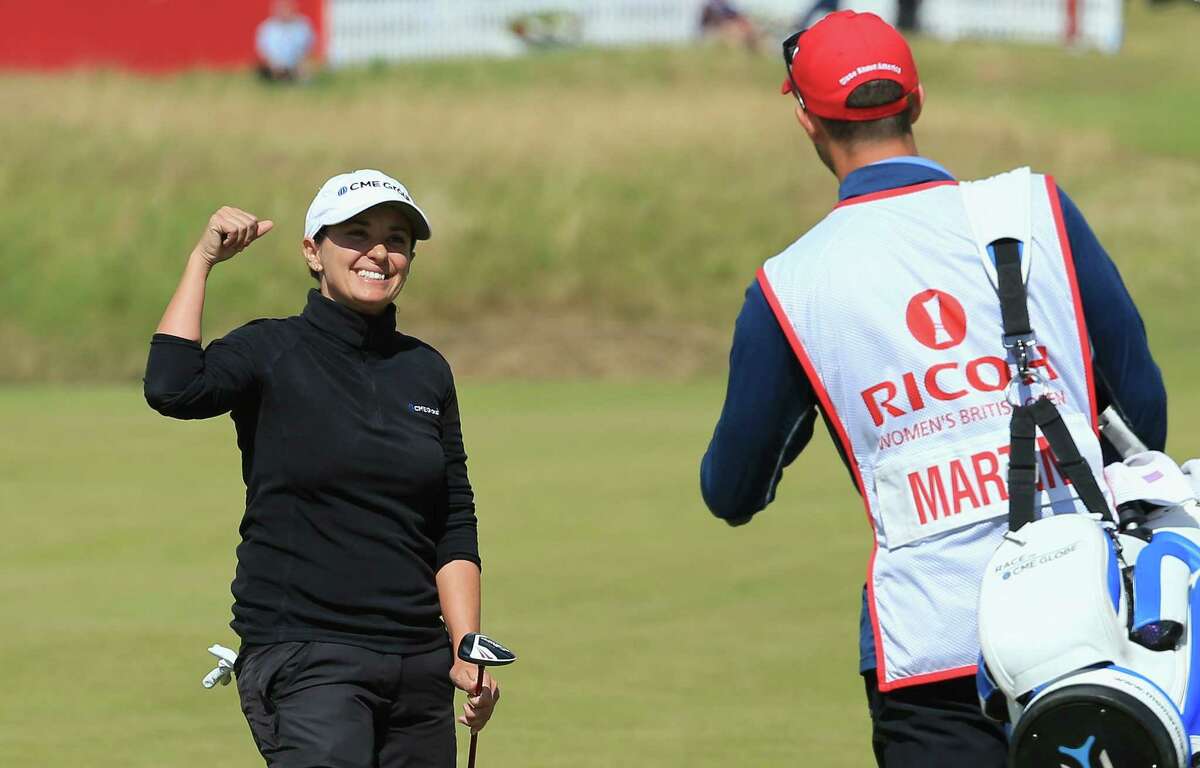 Mo Martin of the United States celebrates her second shot on the 18th hole, which set up an eagle, with her caddie in the final round of the Women's British Open.