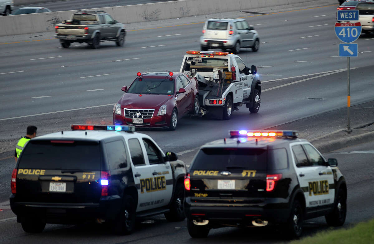 A Cadillac Seville is towed away Monday July 14, 2014 on the westbound Loop 410 access road after it struck a woman crossing lanes at about 4:52 a.m.. San Antonio police sergeant James Lint said a female passenger in the vehicle exited the car and crossed several lanes of traffic when the car looped back around on the highway and struck her. Lint said the people in the same vehicle were involved in a disturbance at a nearby apartment complex earlier. The 24-year-old woman, Priscilla Acosta, later died at University Hospital.