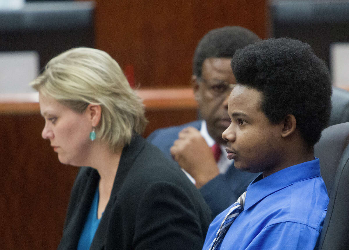 Harlem Lewis, right, sits with his attorneys before his trial begins at the Harris County Criminal Courthouse, Monday, July 14, 2014, in Houston. Lewis, is accused of fatally shooting Bellaire Police Corporal Jimmie Norman and Terry Taylor, a bystander who had to come to Corporal Norman's aid, on December 24th 2012. He could face the death penalty.