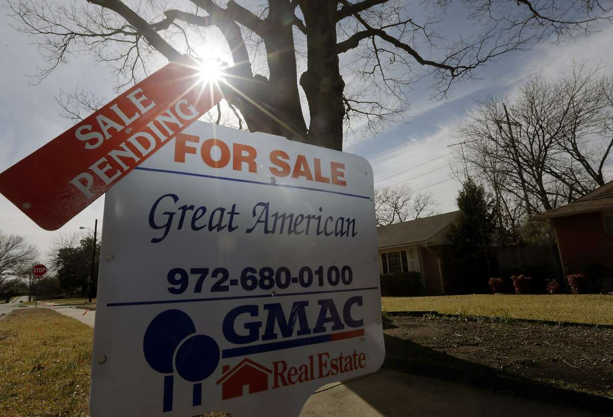 FILE - In this Friday, Feb. 22, 2013 file photo, a sale pending announcement sits atop a for sale sign in a home's yard in Richardson, Texas. National Association of Realtors releases pending home sales index for November on Monday, Dec. 30, 2013. (AP Photo/LM Otero, File)