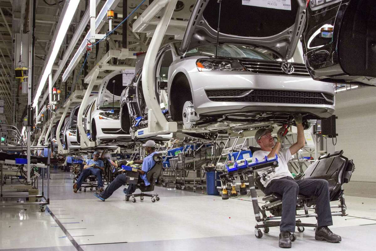 Employees at the Volkswagen plant in Chattanooga, Tenn., work on the assembly of a Passat sedan. Volkswagen said Monday it will build SUVs at the plant.