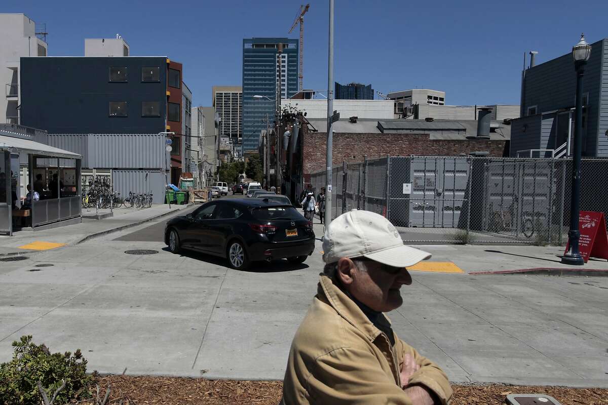 A man walks down Octavia Blvd. past Linden Alley in San Francisco, Calif. on Thursday, July 10, 2014. Linden Alley is being transformed into a more walkable, people-friendly place.