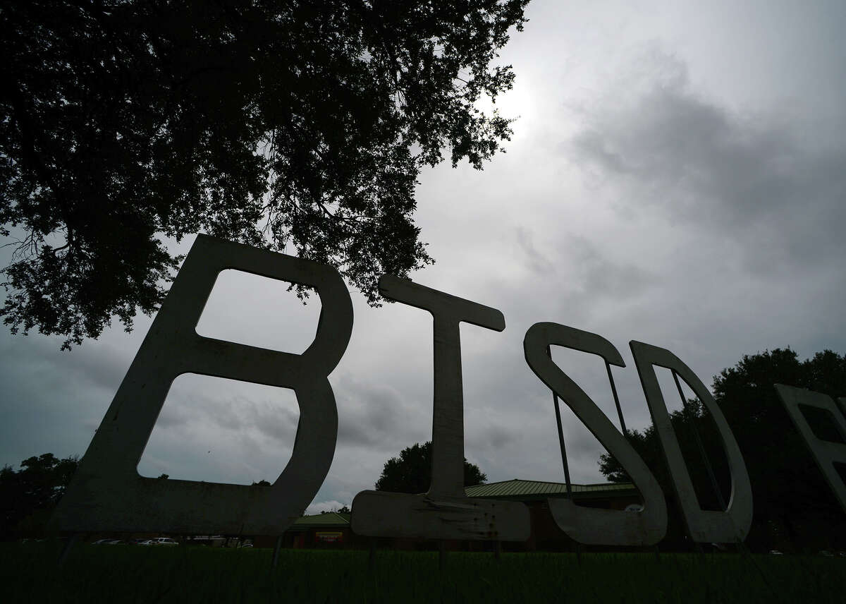 The BISD sign in front of the school district's administration building is partially silhouetted against a cloudy sky Tuesday afternoon. Photo taken Tuesday 7/15/14 Jake Daniels/@JakeD_in_SETX