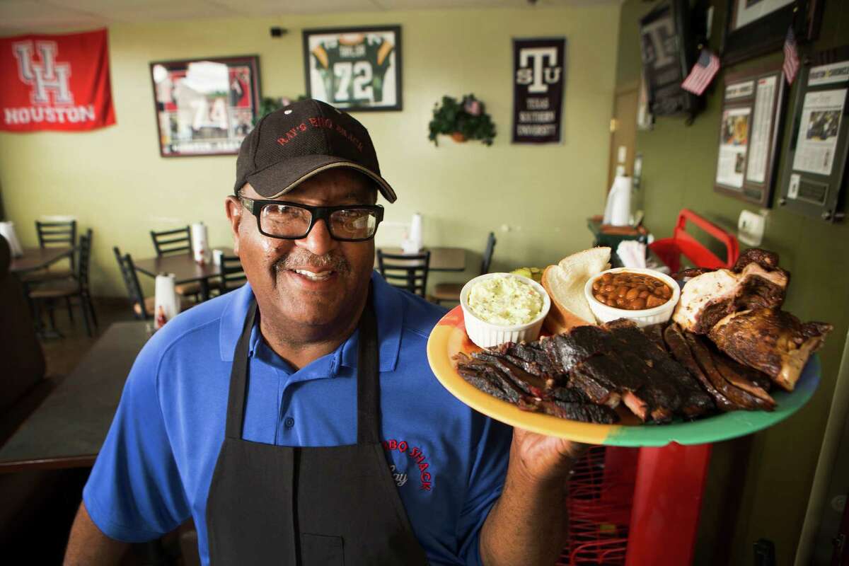 Ray Busch poses for portrait with the House Special at Ray's BBQ Shack.