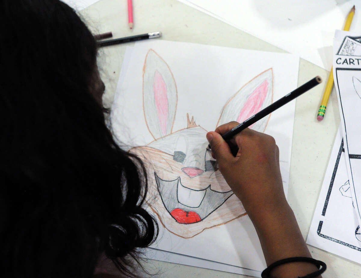 Rubi Garcia, 8, of Greenwich, draws Bugs Bunny during the cartoon workshop taught by art teacher and graphic artist Phil Lohmeyer at the Byram Shubert Library in Greenwich, Conn., Tuesday, July 15, 2014.