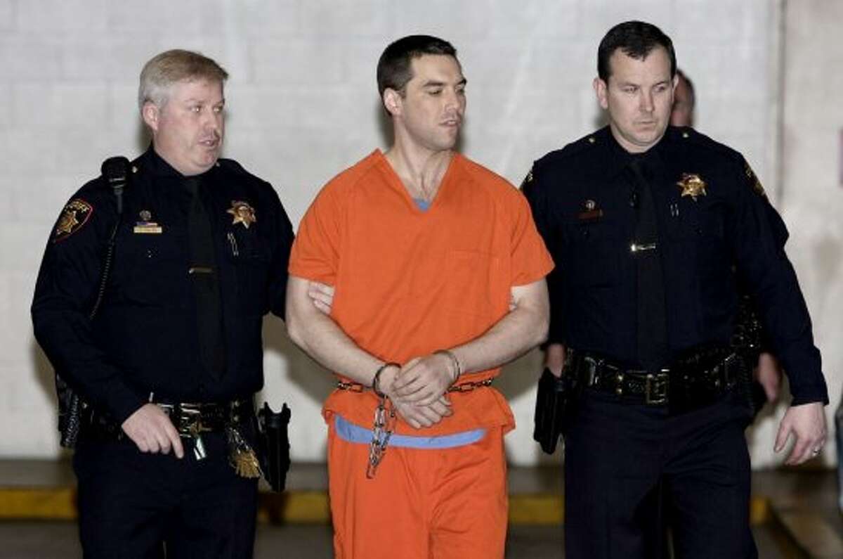 Convicted murderer Scott Peterson is seen being escorted by two San Mateo County sheriff's deputies on March 17, 2005, in Redwood City, California. Peterson was transported to Death Row at San Quentin Prison after being sentenced to death for the murder or his wife, Laci, and their unborn son. Laci Peterson of Modesto was last seen on Christmas Eve 2002.