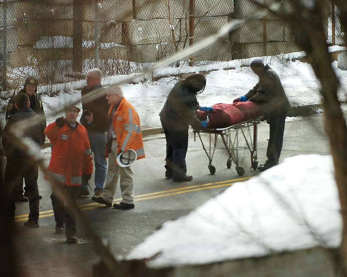 Emergency officials process the scene where a Metro-North train appeared to have hit and killed a person Wednesday morning, Feb. 17th, 2010, as the train crossed Commerce Street just north of the Devine Bros. Inc. fuel depot., in central Norwalk.
