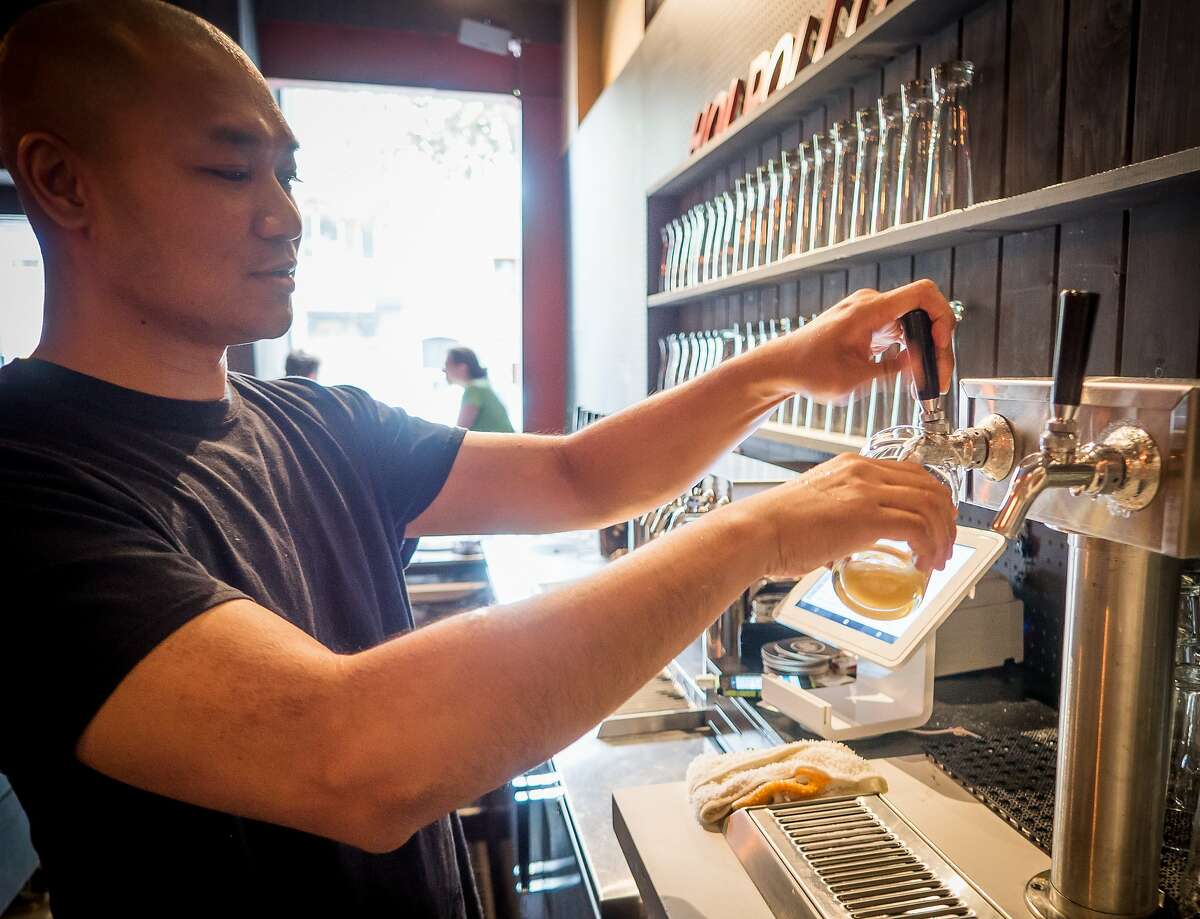 Giap Vu pours a beer at Hoi Polloi in Berkeley, Calif., is seen on Thursday, July 18th, 2014.