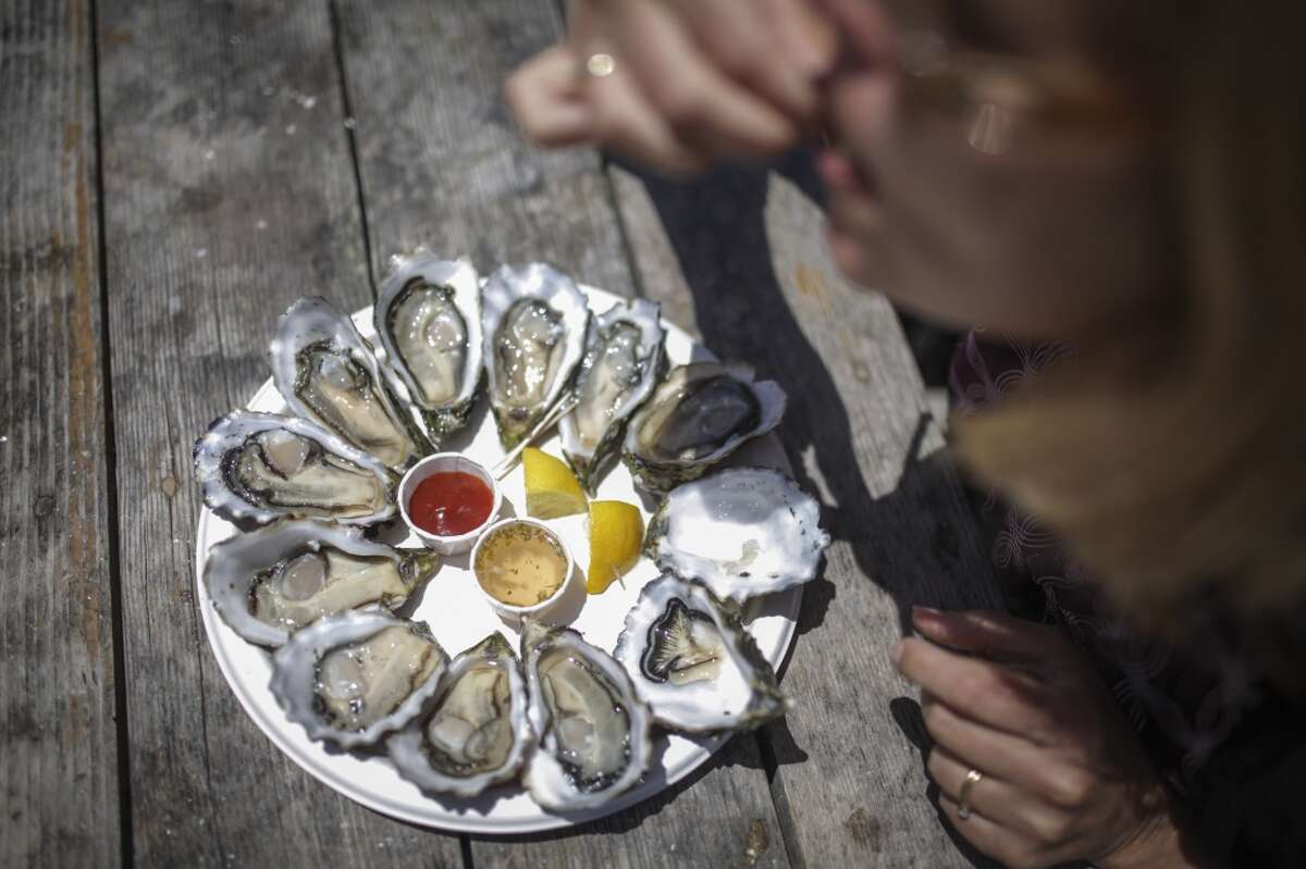Saundra Weddle, from Springfield Missouri, eats an oyster at Drakes Bay Oyster Farm in Inverness on June 30th 2014.