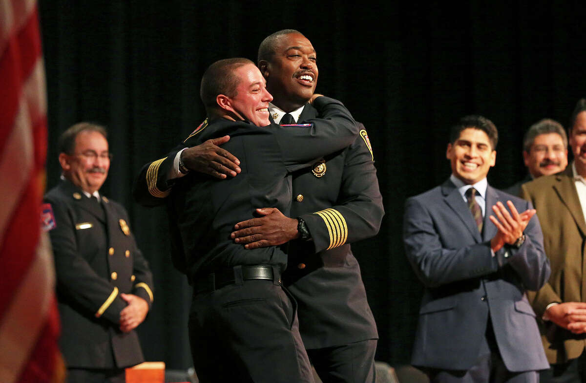 Last to receive his diploma, Christopher Wiley gives a big hug to Fire Chief Charles Hood during the San Antonio Fire Department Cadet Class 2014 Alpha graduation at Antonian College Preparatory High School Auditorium on Friday, July 18, 2014.