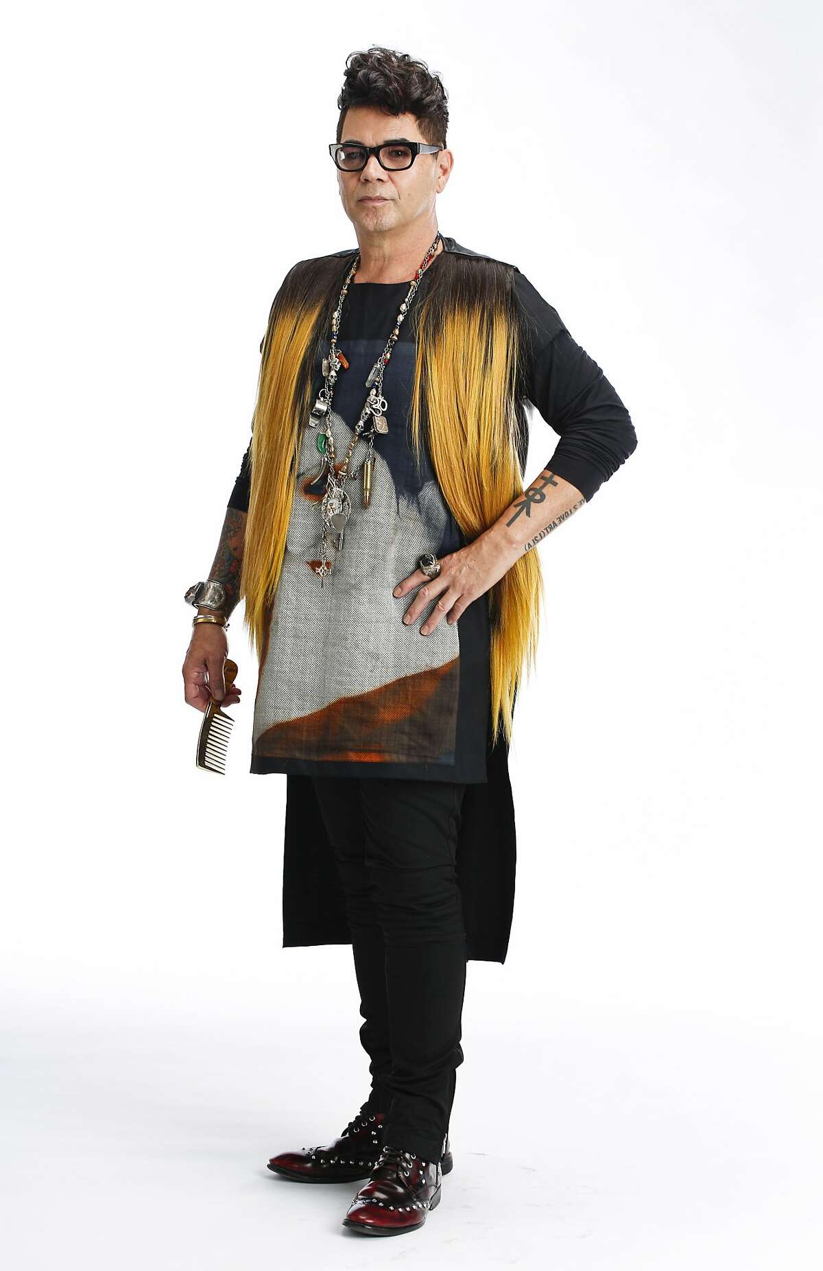 David Reposar, stylist and art director, is seen wearing a self-designed digital geisha tunic, human hair vest designed in collaboration Nancy Bui, DeadRinger necklace assembled with charms collected from his world travels, a meteorite ring, and chunky amber cuff from Poland in San Francisco, Calif., on Tuesday, July 15, 2014.