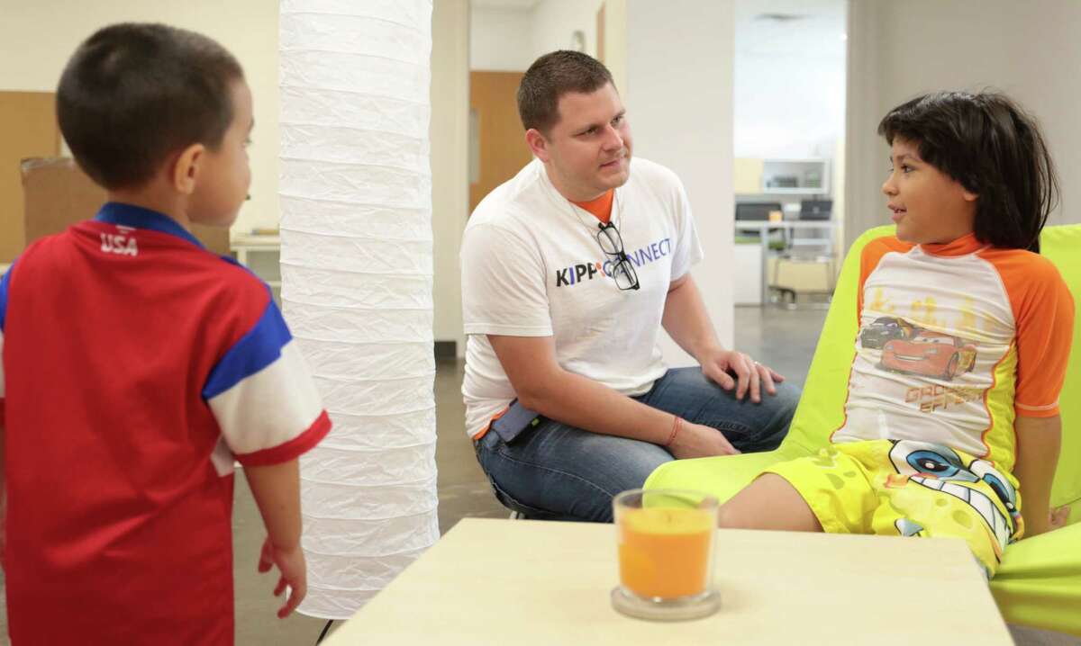 KIPP Connect Campus Assistant Principle Adam Kupac talks with seven year-old Alex Ramirez-Rojas , Thursday July 17, 2014. Alex will be a second grader at the new KIPP campus.