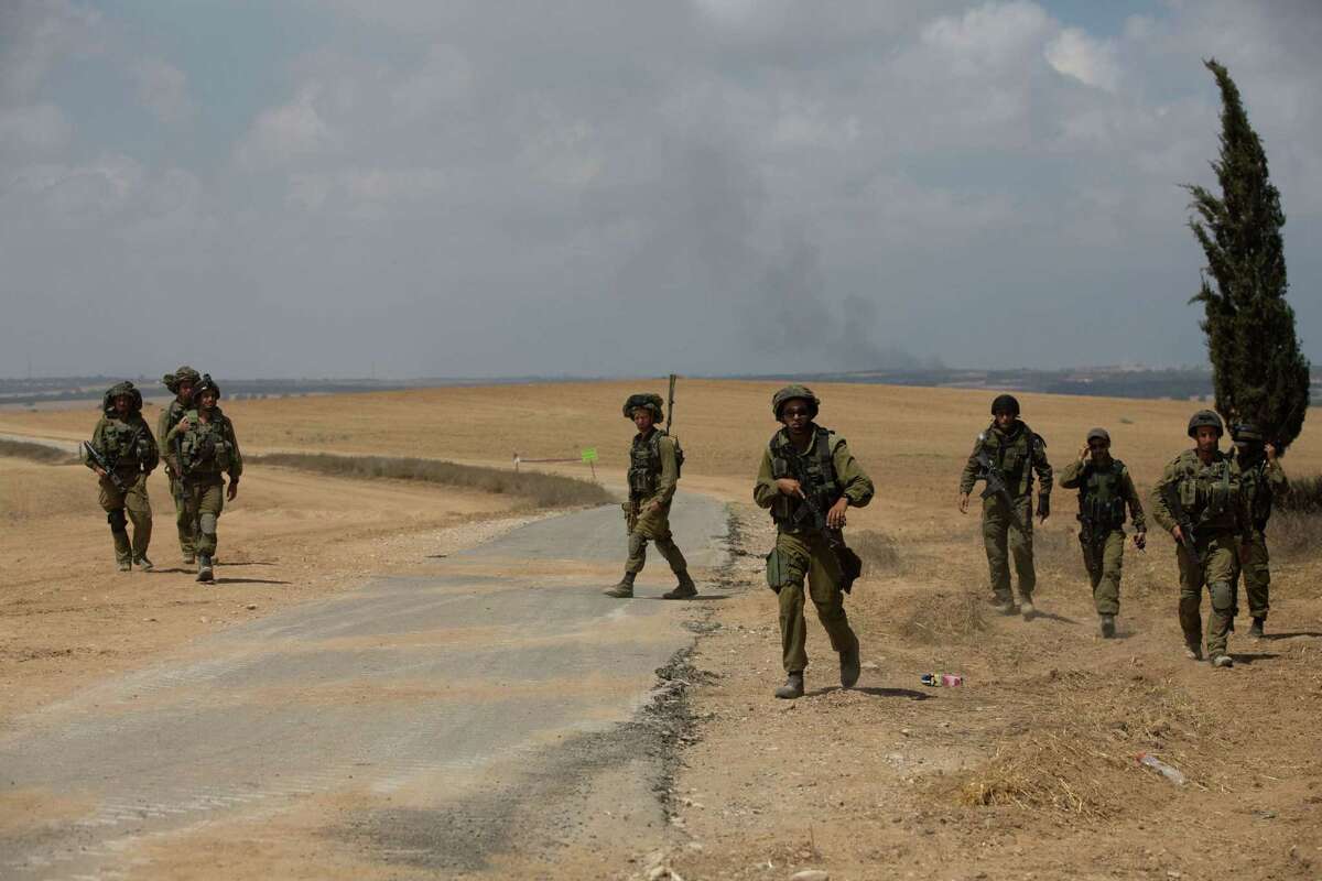 Israeli soldiers secure an area at an army deployment near the Israeli-Gaza border following an exchange of fire between Palestinian militants and Israeli soldiers on July 19, 2014. Israeli strikes killed 20 people in Gaza on July 19, 2014, taking the death toll from a 12-day bombardment to 318, as UN chief Ban Ki-moon headed to the region to join truce efforts. AFP PHOTO /MENAHEM KAHANAMENAHEM KAHANA/AFP/Getty Images