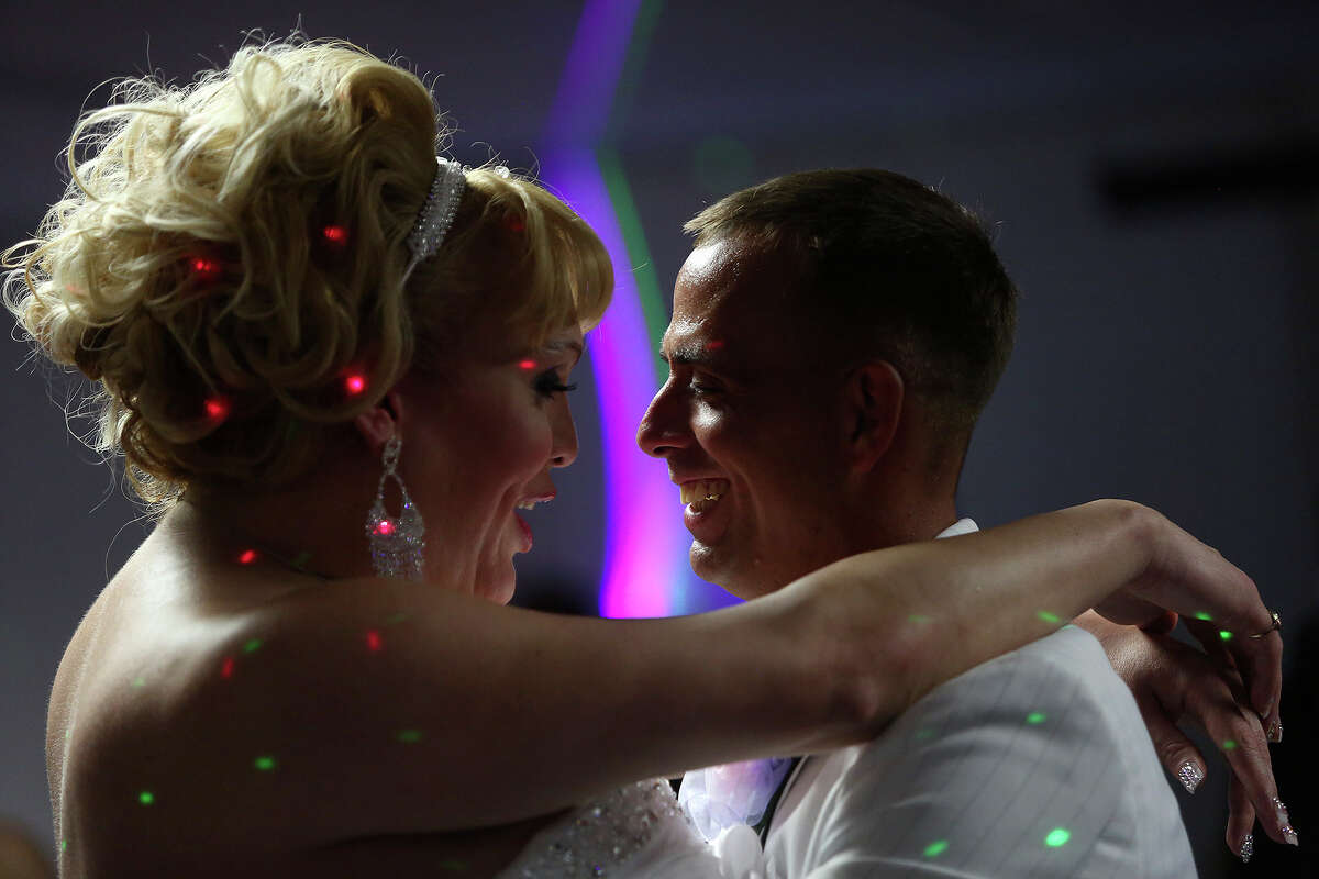 Alexis Valerio and Frank Davis share their "first dance" during their wedding reception at The Montrose Center in Houston on Saturday, July 19, 2014.