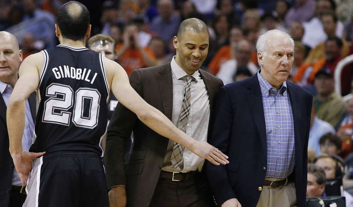 Spurs center Jeff Ayres says assistant Ime Udoka (center) “holds everybody accountable just like Coach Pop (right) does ... only the main difference is he's not yelling as much ...”