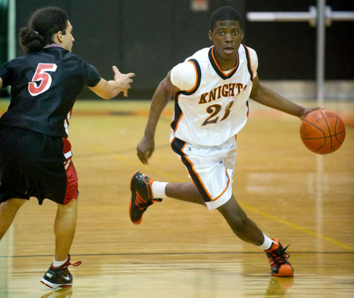 Stamford's Jethro Anilus, right, drives past Central's Chris Colon, left, during an FCIAC boys basketball game at Stamford High School in Stamford, Conn. on Wednesday, Feb. 17, 2010.