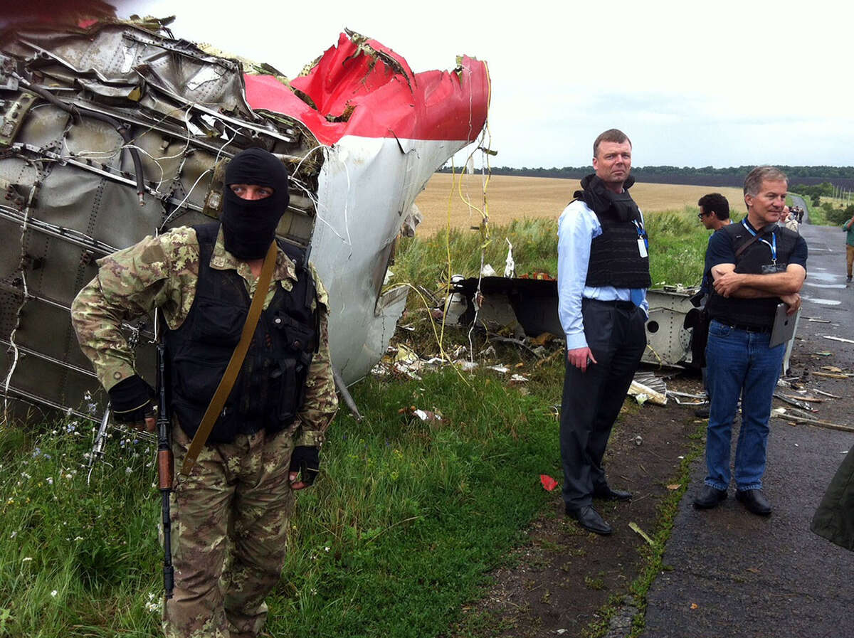 Alexander Hug (2nd L), Deputy Chief Monitor of the Organization for Cooperation and Security in Europe's (OSCE) Special Monitoring Mission to Ukraine, visits the site of the crash of a Malaysian airliner carrying 298 people from Amsterdam to Kuala Lumpur, near the town of Shaktarsk, in rebel-held east Ukraine, on July 18, 2014. Pro-Russian separatists in the region and officials in Kiev blamed each other for the crash, after the plane was apparently hit by a surface-to-air missile. All 298 people on board Flight MH17 died when the plane crashed.