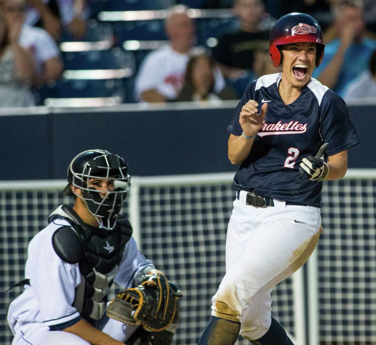 Mandie Fishback of the Stratford Brakettes celebrates scoring a run in the top of the 5th inning during a softball game against the Bridgeport Bluefish played at the Ballpark at Harbor Yard, Bridgeport, CT on Sunday, July, 20th, 2014.