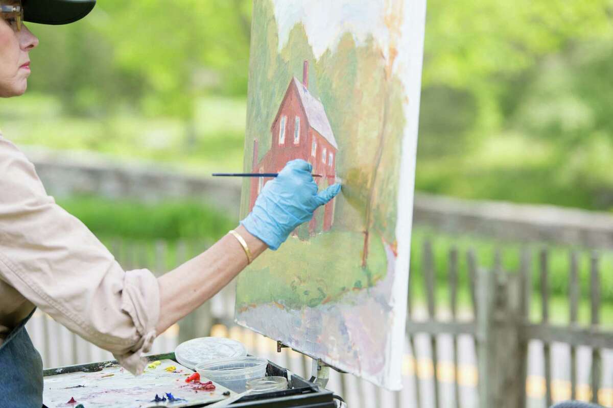 An artist paints at Weir Farm National Historic Site on the border of Ridgefield and Wilton.