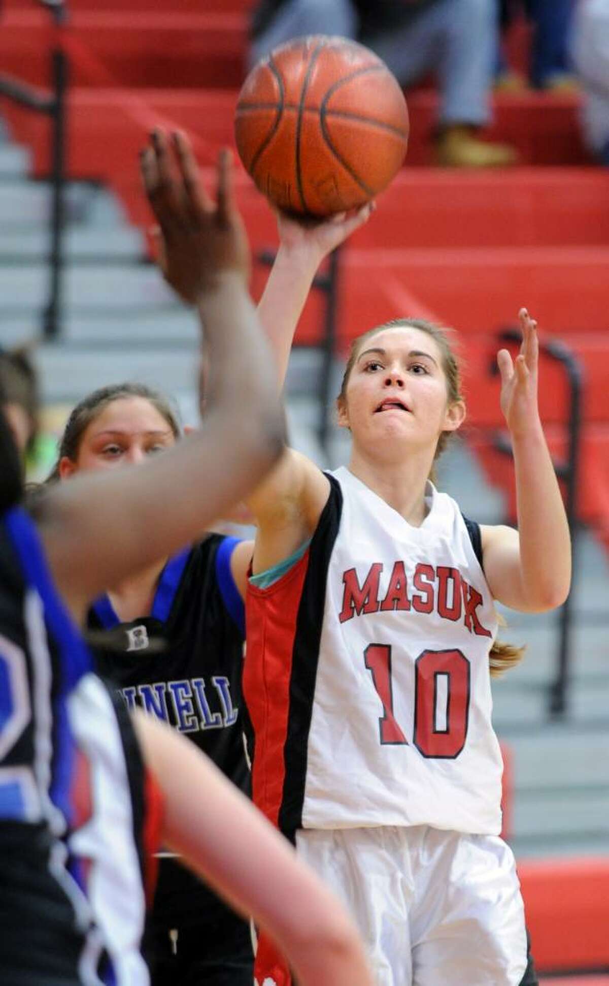 Masuk's Colleen Courbron puts up the ball during the first half of game action against Bunnell Wednesday Feb. 17, 2010 at Masuk.