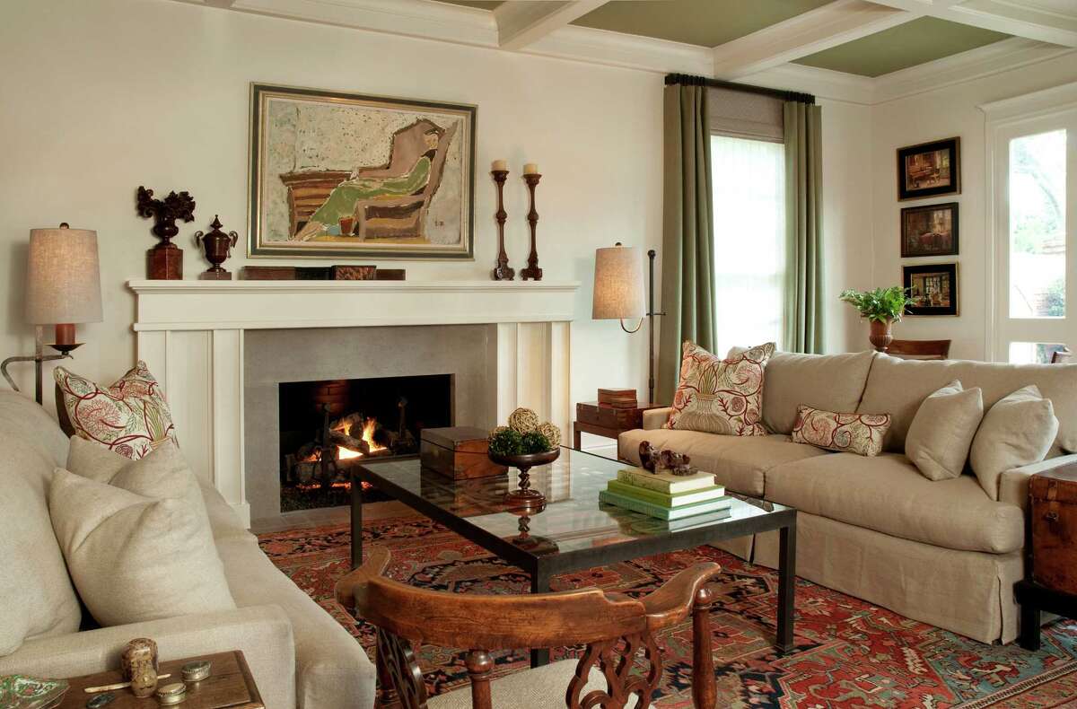 In the living room, Sandy Lucas brought in a large-scale fireplace mantel to match the scale of the space, topped with antique French carved-walnut candlesticks found at Round Top, an 18th-century carved urn found at the Theta Charity Antiques Show and several antique glove boxes.