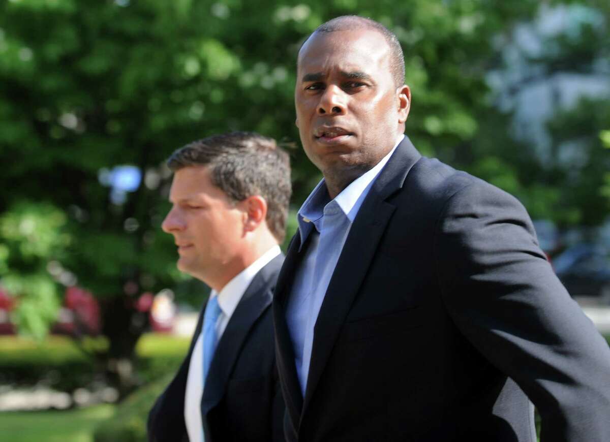 Former Ducks player Jose Offerman, right, and his attorney, Frank Riccio, Jr, arrive at the federal courthouse in Bridgeport, Conn. on Thursday, July 17, 2014. Offerman is being sued by former Bluefish catcher Jonathan Nathans for injuries sustained in a charging the mound incident in a 2007 game between the two teams.